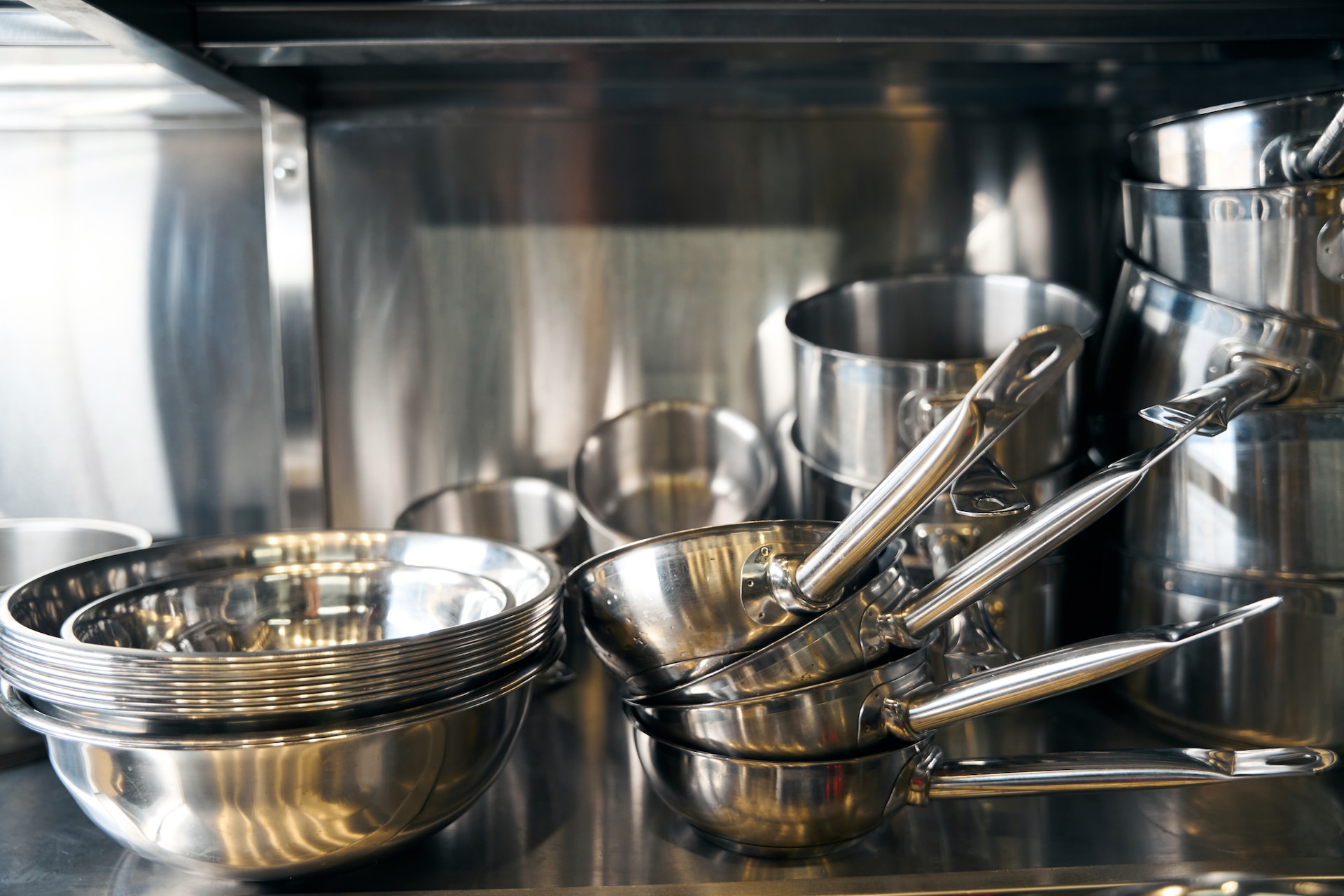 Understanding Grade 430 Stainless Steel Table with metallic pans and bowls in modern restaurant Understanding Grade 430 Stainless Steel